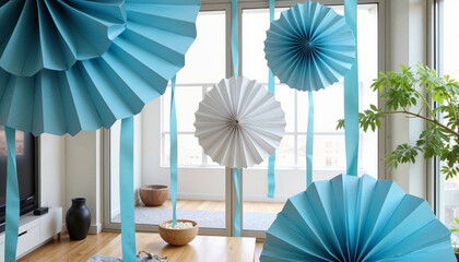 Blue and white paper fans hanging in bright room