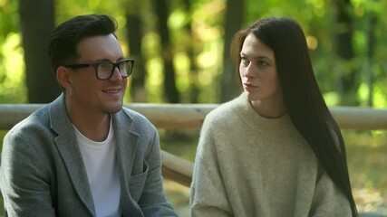 A couple enjoying a peaceful moment together in a forest setting, showcasing connection and contemplation.