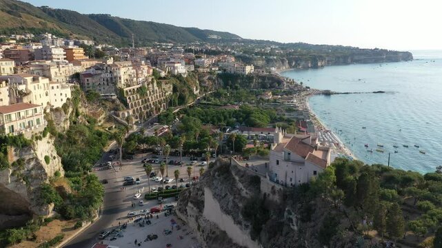 Aerial view of cliffs, historic tourist center of the city, monastery Santuario di Santa Maria dell'Isola di Tropea sunny summer day in Calabria region, Italy
