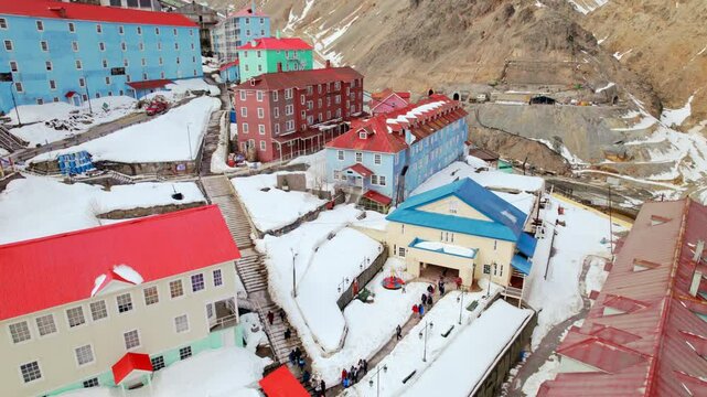 Colorful buildings covered in snow in Sewell, a historical mining town in the Andes