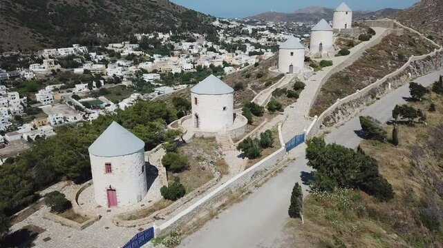 Greece,Leros Island,Drone Footage of the famous windmills of the Island, focusing primarily on the windmills, starting from the top of the hill and zooming out slowly and capturing 5 mills at the end