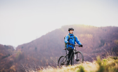 Active man on bike in the middle of beautiful nature, enjoying beautiful view. Concept of healthy...