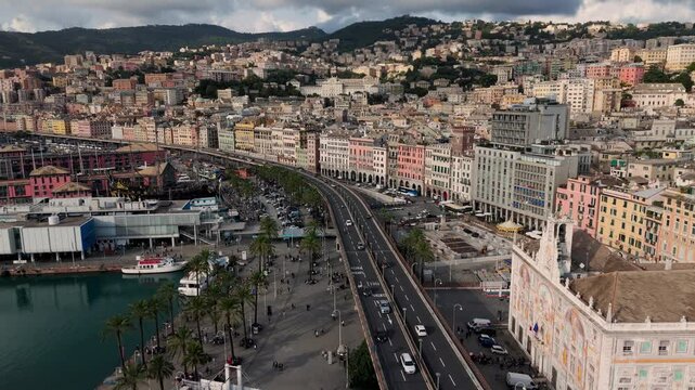 Porto antico in genoa showing colorful buildings, busy streets, and a harbor, aerial view