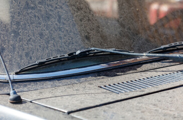 A dirty windshield with wipers on it