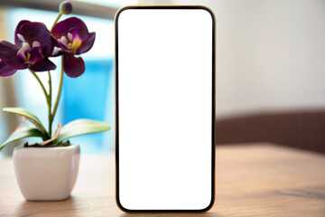 phone with isolated screen on table background with orchid flower