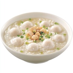 A bowl of rice porridge topped with meatballs and green onions, showcasing a comforting meal.