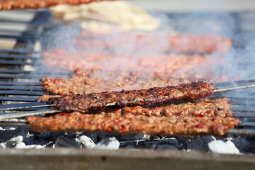 grilling adana kebap which is made from minced lamb meat
