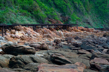 A wooden bridge on the edge of a rocky mountainside