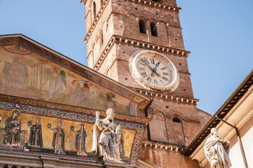 Clock and bell tower of  Basilica of Santa Maria in Trastevere district, Rome, Italy