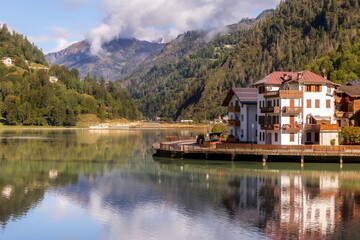 Fototapeta premium Alleghe, Italy houses and lake in Dolomites Alps