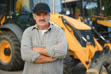 Construction driver with excavator on the background