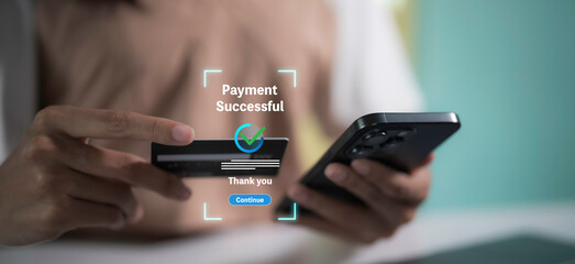 Payment successful concept.Hand holding credit card and smartphone with Payment successful.Online Money Transfer Confirmed.Concept of e-commerce and online banking, payment transfer