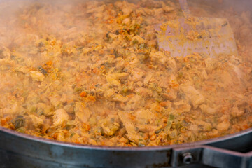 Steaming chicken and vegetables simmer in a large pot, creating a delicious aroma