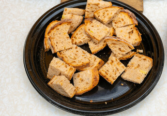 A plate of toasted bread, ready for dipping, sits on a table at a food market