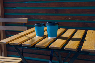 Coffee Cups on a Wooden Outdoor Table