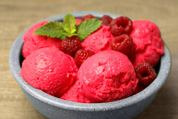 Delicious raspberry sorbet, fresh berries and mint in bowl on light table, closeup