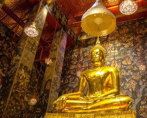 A large gilded Buddha statue, Luang Pho To, Wat Kalyanimit, Bangkok, Thailand, is sacred and highly revered by the people.