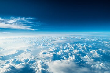 A beautifully captured view of Earth from space, displaying the vastness of the planet and its enveloping atmosphere, surrounded by a sea of white, fluffy clouds.