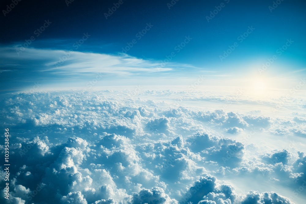 Poster a stunning aerial view of dense, white clouds illuminated by the setting sun, casting warm hues and 