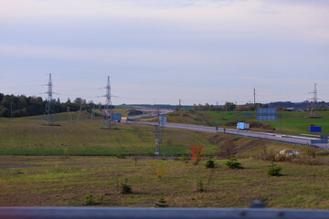 Wide road, highway, sun and blue sky on a summer day.