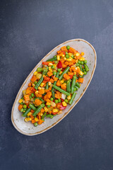 Mexican Mix of Vegetables. Tomatoes, Green Beans, Peas, Corn. Dietary Food.Bright vegetable mix .Vegetarian food.Assorted.