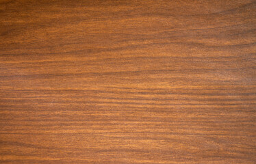 Photo of the texture of a mahogany colored wooden background.Wooden background for the text.