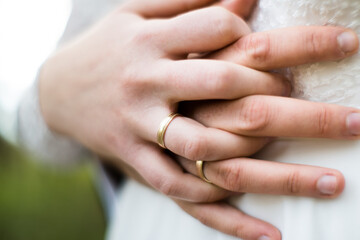 A pair of newlyweds holding hands.

