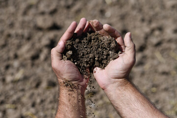 Soil in hands. Farmer with soil mud in hands. Gardening. Agriculture concept. Mud on field. Soil for growing plants. Clean soil for cultivation and gardening.