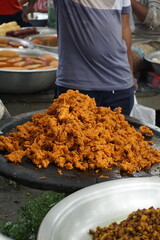 Mix vegetable pakora making and being displayed by a street food vendor, Crispy onion and potato pakoda selling on a market, Spicy veg pakora or pakoda displayed on a rural fair for sale