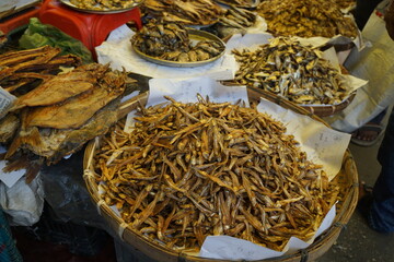 Mixed dried fish are displayed and sold at a fish market, Different types of dried fish are sold by a street vendor, All types of dried salted fish in the Asian biggest seafood market