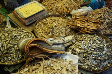 Mixed dried fish are displayed and sold at a fish market, Different types of dried fish are sold by a street vendor, All types of dried salted fish in the Asian biggest seafood market