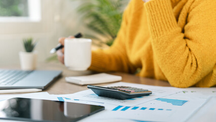 Businesswoman Accounting, Calculating income-expenses and analyzing investment data reports. Annual tax reduction planning concept, financial and tax systems.