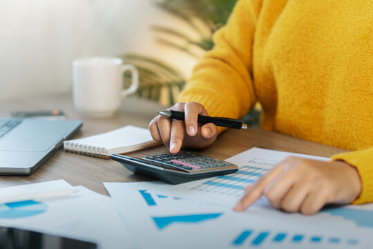 Businesswoman Accounting, Calculating income-expenses and analyzing investment data reports. Annual tax reduction planning concept, financial and tax systems.