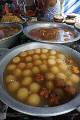 Popular Bangladeshi dessert Gulab Jamun with sugar syrup, Traditional Bangladeshi sweet called rasgulla or rasgoola is being sold at a market, Gulab jamun and rasgulla are displayed together