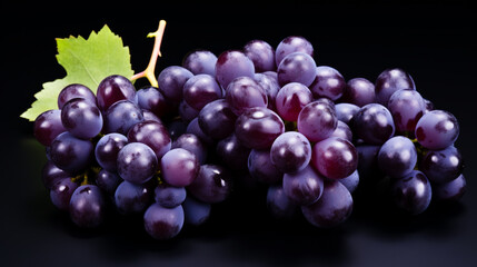Fototapeta premium Close up of fresh organic farm grown red grape bunch on black background.