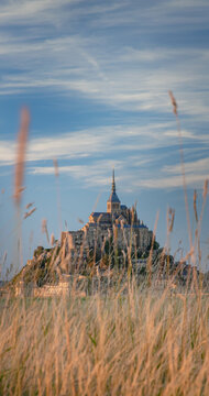 Le Mont Saint-Michel island with a blade of grass and clouds, Normandy, France. France