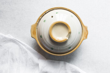 Overhead view of japanese donabe on a marble countertop, top view of japanese countertop on a white background