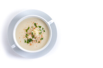 Cauliflower soup in bowl isolated on white background. Top view. Copy space