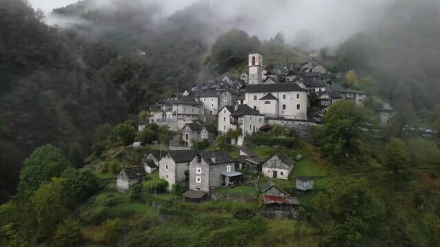 Aerial view of Corippo, Valle Verzasca in Autumn in Switzerland with foggy mountians at the background.