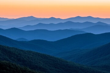 Fototapeta premium A peaceful scene unfolds as dawn breaks over misty mountains, casting a serene and tranquil atmosphere that heralds the promise of a new day with stunning views.