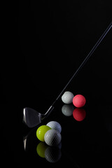 golf club and golf ball photographed against a dark background