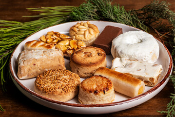 Plate with various Christmas sweets, mantecado, donut, nougat, marzipan among other sweets, close-up.