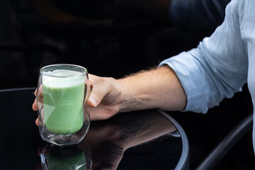 Hand Holding Glass Of Premium Japanese Matcha Tea