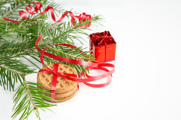 Christmas tree branch, cookies and red decoration