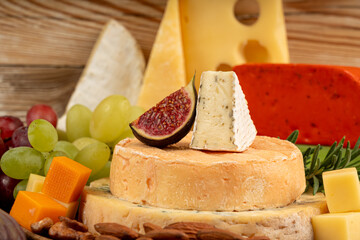 Cheese plate of color cheeses variety, yellow, white and blue cheese board, assorted dairy products