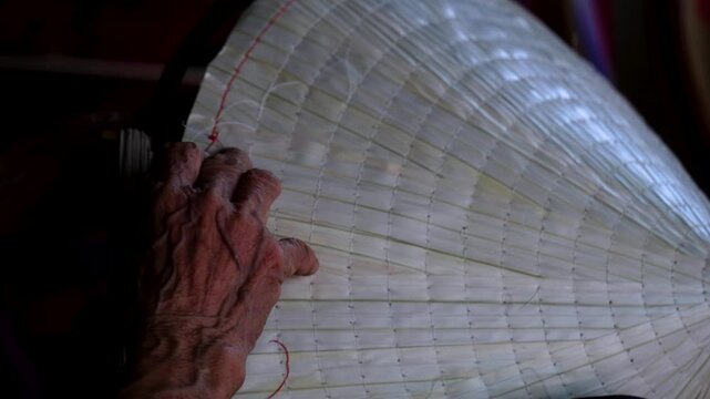 old woman making conical hats - Vietnamese name is Non la. Lang Chuong village, Hanoi city, Vietnam