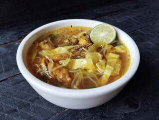 Soto ayam or chicken noodle soup with vegetables, Indonesian traditional foods famous in Java 