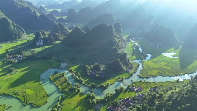 Aerial landscape in Quay Son river, Trung Khanh, Cao Bang, Vietnam with nature, green rice fields and rustic indigenous houses