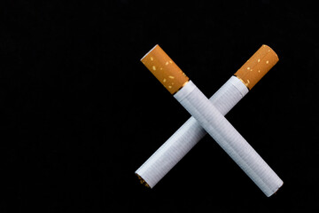 Concept of harm of smoking cigarettes on dark background.