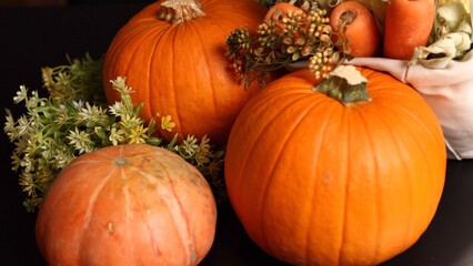 Pumpkins with carrots evoke cozy autumn harvest vibe. Warm festive rustic feel enhances seasonal charm, creating ideal atmosphere for autumn gatherings, harvest decor, indoor setup.